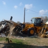 The loader is used to push the debris to the side of the road.